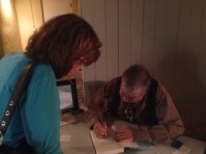 Bernie Schein signs my copy of his novel Famous All Over Town.