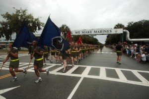 New Marines of Kilo Company, 3rd Recruit Training Battalion, run under the “We Make Marines” sign during a traditional motivational run through the streets of Parris Island, S.C., on Aug 15, 2013. The run took place before the new Marines had a few hours to reunite with their friends and families for the first time in more than 12 weeks. (Photo by Cpl. Caitlin Brink)