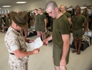 Staff Sgt. Jamison Randolph, the senior drill instructor of Platoon 2080, Fox Company, 2nd Recruit Training Battalion, inspects a package for Rct. Cole Jones, also with Platoon 2080, during mail call Aug. 11, 2014, on Parris Island, S.C. Drill instructors must inspect the contents of parcels to ensure recruits receive no contraband while in training. Most recruits’ only connection to the outside world during their 13 weeks on Parris Island is through letters from friends and family. Randolph, 29, is from Marion, N.C. Jones, 18, is from Jacksonville, N.C., and is scheduled to graduate Oct. 24, 2014. (Photo by Cpl. David Bessey)