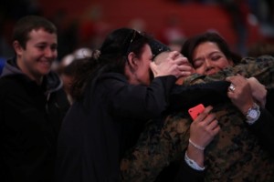 Family members tightly embrace their new Marine of Alpha Company, 1st Recruit Training Battalion, following the Family Day ceremony Jan. 23, 2014, on Parris Island, S.C. (Photo by Cpl. Octavia Davis)