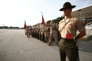 Staff Sgt. Victor Lucio, senior drill instructor of Platoon 1044, Alpha Company, 1st Recruit Training Battalion, stands with his platoon as they wait to begin their final drill evaluation June 5, 2013, on Parris Island, S.C. (Photo by Lance Cpl. MaryAnn Hill)