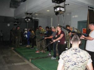 Practice firing at the Indoor Simulated Marksmanship Trainer during the Educator's Workshop (Photo by Vera Basilone)