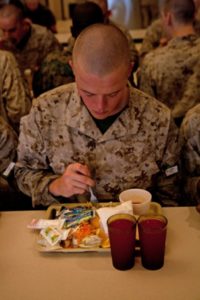 Recruit eating a hot meal at the mess hall. Male recruits consume approximately 3,950 calories and females consume 2,700 calories each day (Photo by Lance Cpl. David Bessey)