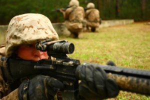 A recruit sights in, in the prone position to provide cover for the rest of his squad during the Crucible at Page Field. (Photo by Lance Cpl. Javarre Glanton)