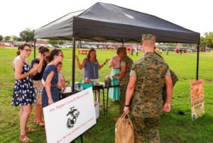 A group of Marines share snacks and drinks with members of Pvt. Pepper’s Lonely Hearts Club. (U.S. Marine Corps photo by Staff Sgt. Tyler Hlavac)