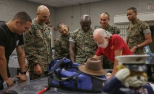 Former Marine Sgt. Al Pasquale, the event coordinator of 2nd Battalion’s reunion, shows class photos to current drill instructors and command leadership from 2nd Recruit Training Battalion. (U.S. Marine Corps photo by Lance Cpl. Ryan Hageali)