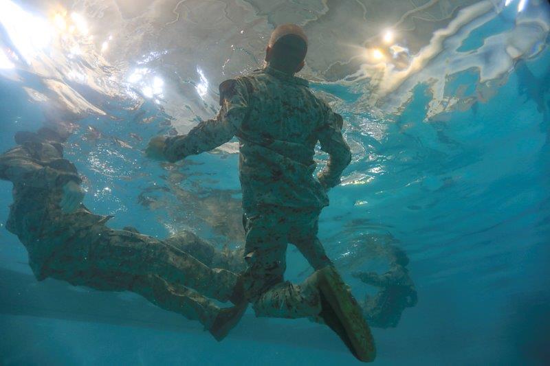 A U.S. Marine Corps recruit with India Company, 1st Recruit Training Battalion, conducts swim qualification at the combat training pool on Parris Island, S.C. After demonstrations, recruits are tested on their ability to jump into deep water, shed proper equipment, and tread water in full utilities. (U.S. Marine Corps Photo by Cpl. Shane Manson)