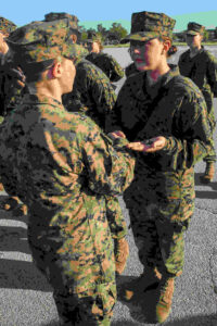 U.S. Marine Corps Pvt. Emily K. Valley, shakes hands with her drill instructor after earning the Eagle, Globe and Anchor emblem. (U.S. Marine Corps photo by Cpl. Vanessa Austin)