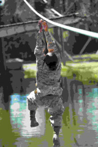 Rct. Jessica Perez lets go of a rope on a Confidence Course obstacle. The obstacle requires recruits to slide across a horizontal rope without falling into the pond beneath. (U.S. Marine Corps photo by Lance Cpl. Vaniah Temple)