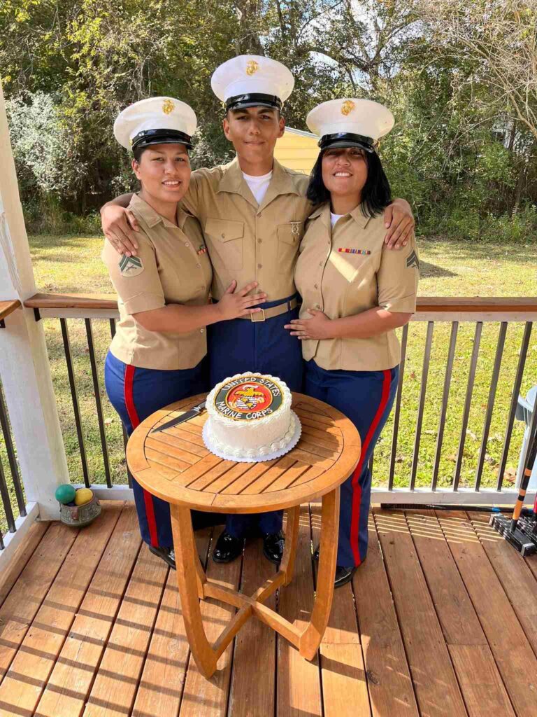 Cpl. Astrid Ramos Roman, an administrative clerk with Force Headquarters Group, Marine Forces Reserve, (left) Pfc. Joel Mendoza, student at Logistic Operation School North Carolina, (middle) Cpl. Ashly Mendoza, a finance technician with Combat Logistics Regiment, 3rd Marine Logistics Group, (right) pose for a photo celebrating Joel’s Marine boot camp graduation. (U.S. Marine Corps courtesy photo by Cpl. Astrid Ramos Roman)